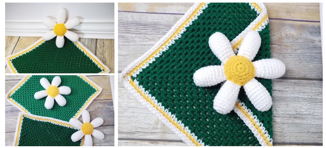 White daisy petals around a yellow center on a green square blanket